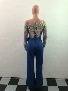 Detail of the back hidden zipper and gold lace embroidery on the elegant jumpsuit