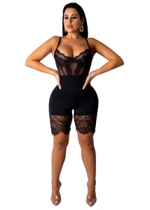 Close-up of black lace bodysuit featuring sheer mesh panels and floral lace trimming