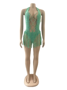 Detail of mint green crochet beach cover-up with criss-cross lace-up and long tassels