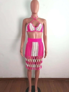 Detail of crochet knit two-piece set featuring pink and white stripes with fringe hem