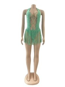Detail of mint green crochet knit texture with long fringe on a beach cover-up