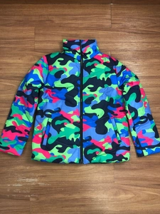 Flat lay of colorful camouflage puffer jacket with vibrant pink and green patterns