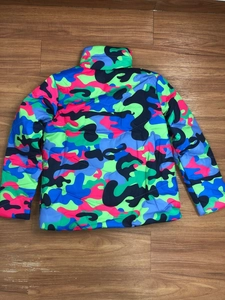 Macro view of colorful graffiti camouflage pattern on a quilted winter puffer jacket