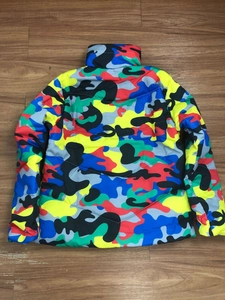 Detail view of colorful camouflage puffer jacket with vibrant red and blue patterns