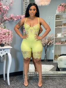 Detailed front view of lemon yellow lace bodysuit with sheer mesh panels and floral trim