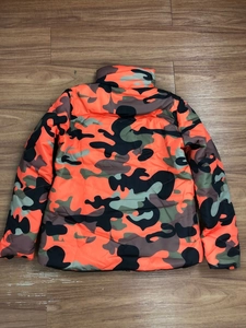 Detailed back view of puffer jacket featuring bold orange and green camo print pattern