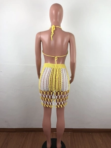 Back view of yellow and white crochet two-piece set featuring hollow knit texture