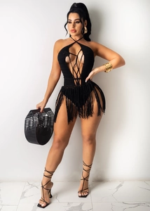 Detail shot of black crochet bodysuit with lace-up front and long fringe tassels