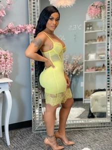 Detailed view of yellow lace patchwork mini dress with sheer mesh paneling and corset straps