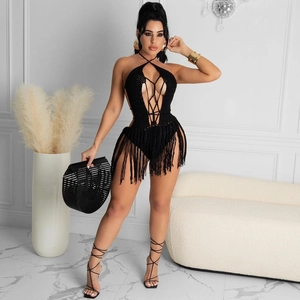 Detail of black crochet halter beach cover-up with criss-cross straps and long fringe hem