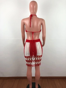 Detail of red and white handmade crochet beach set with fringe hem and mesh knit