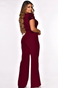 Detail of wine red sequin stitching on the sleeves and back of the jumpsuit