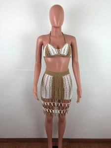 Detail of crochet two-piece set featuring color-blocking knit pattern and fringe tassels