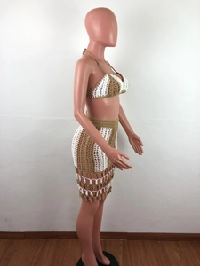 Detail view of the intricate crochet weave and fringe on a boho beach set