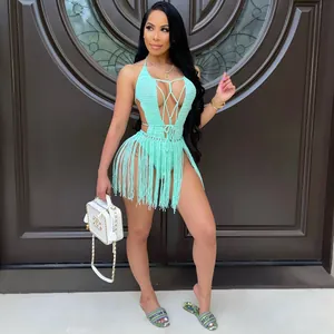 Close-up of mint green crochet cover-up with deep V-neck, lace-up front, and long fringe