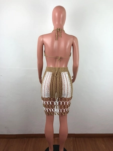 Detail of bohemian crochet knit two-piece set featuring brown and white patchwork patterns