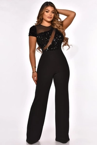 Detail of sequin mesh patchwork and wide-leg cut on the black party jumpsuit