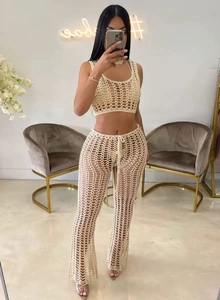 Detail of off-white crochet two-piece set featuring knit hollow mesh texture and wide legs