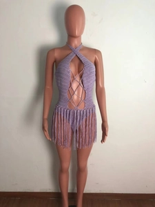 Detail of lavender crochet halter bodysuit featuring criss-cross lacing and long fringes