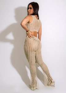 Detail of handmade crochet hollow mesh texture on beige two-piece beach set for women