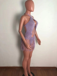Detailed side view of purple crochet halter jumpsuit with long fringe and lace-up front