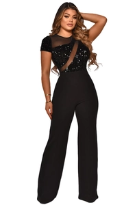 Detail of black jumpsuit with sequin embroidery and sheer mesh patchwork design