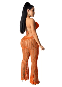 Detail view of orange crochet two-piece set featuring hollow mesh knit texture and fabric