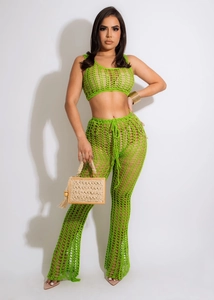 Green crochet two-piece set featuring a mesh halter top and flared hollow-out pants