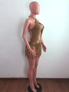 Side view of olive green crochet knit beach dress featuring waist cut-outs and long fringe