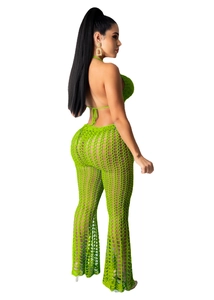 Detail of bright green crochet two-piece set featuring hollow mesh knit and halter neck