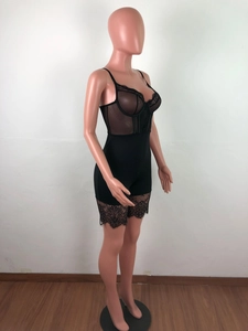Detail of black lace bodysuit featuring floral mesh patterns and eyelash lace hem on the thighs