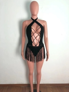 Detail of black crochet halter bodysuit with criss-cross lacing and fringe skirt detail