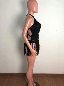 Detailed side view of black crochet beach dress with fringe and side lace-up design