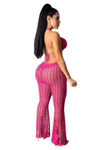 Detail of hand-crocheted mesh texture on rose red halter top and flared trousers set
