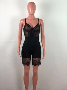 Detailed view of black floral lace and sheer mesh patchwork on a slimming bodysuit