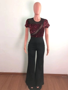Detail of burgundy sequin bodice with sheer black mesh patchwork on short sleeve jumpsuit
