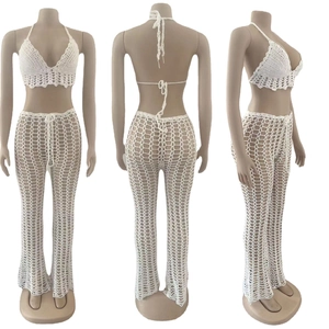 Detailed close-up of white crochet two-piece set featuring handmade hollow mesh texture