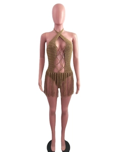 Detailed knit texture of a khaki crochet beach coverup with fringe hem and hollow-out design