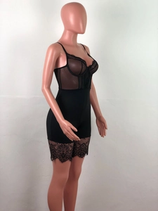 Close-up of black lace bodysuit with sheer mesh panels and eyelash lace trim details