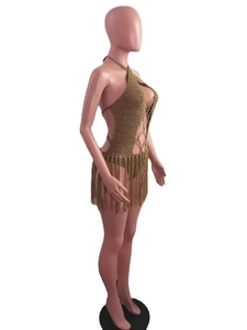 Detail of olive green crochet beach dress featuring halter neck and long tassel fringes