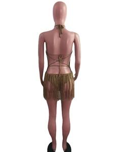 Detail of crochet beach cover-up featuring open-back criss-cross ties and long tassels
