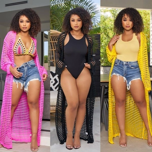 Detailed knit texture of long crochet beach cover-ups in pink, black, and yellow