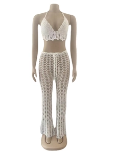 Detail of white crochet hollow-out two-piece set featuring lace trim and mesh beachwear texture