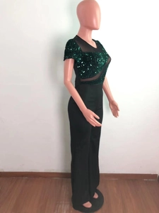 Detail of black jumpsuit with green sequins and sheer mesh on the short sleeves