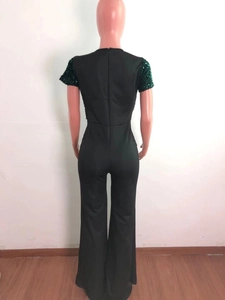 Detail view of the back zipper and sequin short sleeves on this dark green jumpsuit