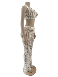 Detail view of white crochet mesh texture and deep V-neck design on hollow out beach set