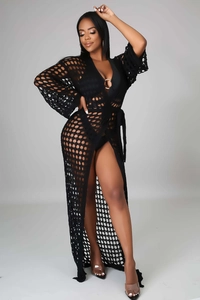 Detailed knit pattern of a black crochet beach cover-up with a long-sleeved V-neck design