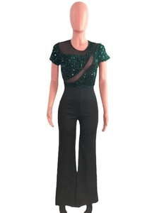 Detail of sequin stitching and sheer mesh insert on the dark green jumpsuit bodice