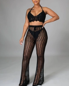 Detail of black crochet two-piece set featuring hollow-out knit patterns and wavy edges