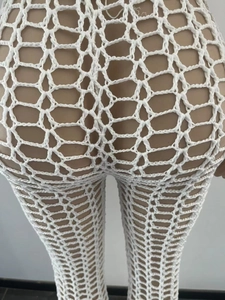 Close-up of white crochet beach pants featuring hexagonal hollow mesh and handmade texture